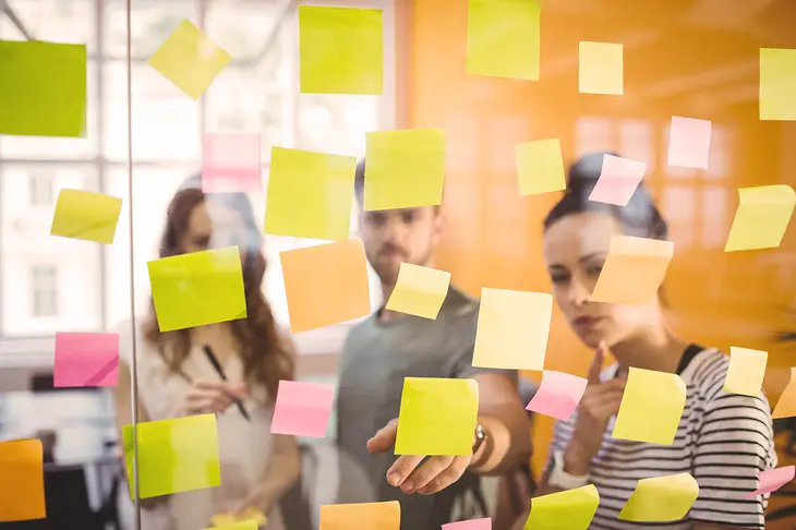 A group of diverse professionals collaborating around a digital screen, symbolizing the importance of collaboration and leveraging technology for innovation in the digital age